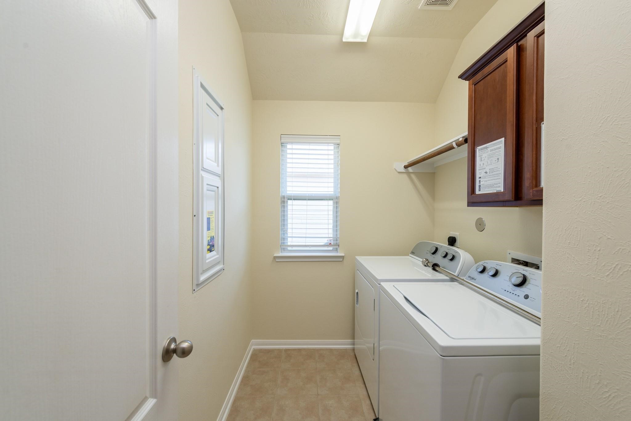 6402 Addlestone Ridge Lane Katy, TX 77494 - Photo 19 of 25 Convenient upstairs laundry room includes a washer and dryer and is ideally located near all bedrooms, making laundry day easier and eliminating trips up and down the stairs. Natural light and overhead storage cabinetry add functionality and convenience.