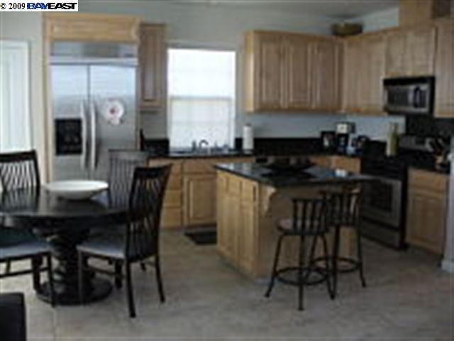 a kitchen with a table chairs sink and cabinets