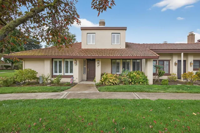 a front view of a house with a garden