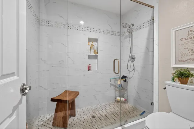 a bathroom with a sink vanity granite tub and shower
