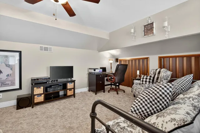 a bedroom with furniture and a flat screen tv