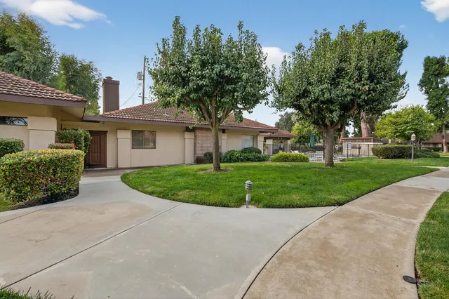 a front view of a house with a garden