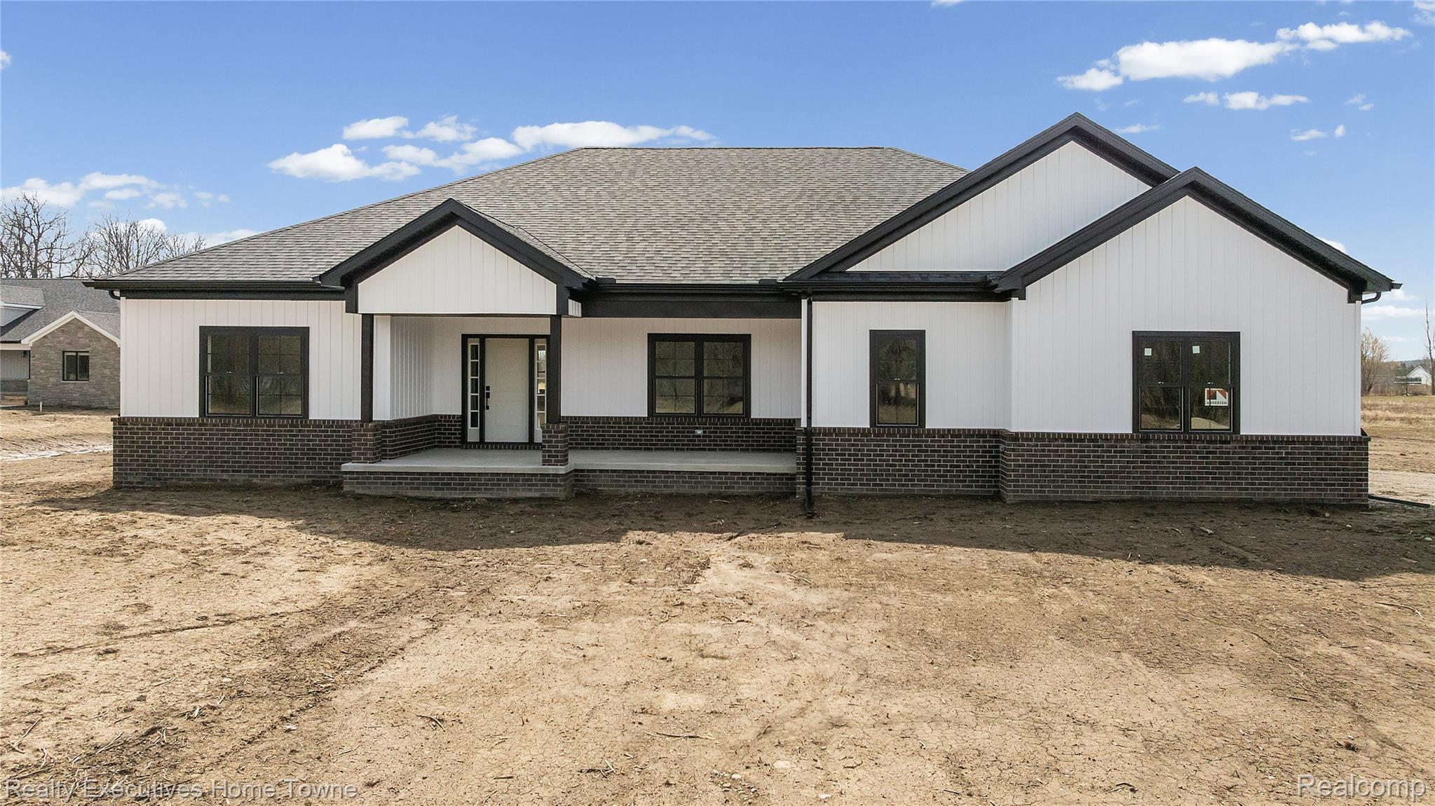 26850 Irwin Road Richmond, MI 48062 - Photo 31 of 47 View of front of home featuring brick siding, covered porch, and a shingled roof