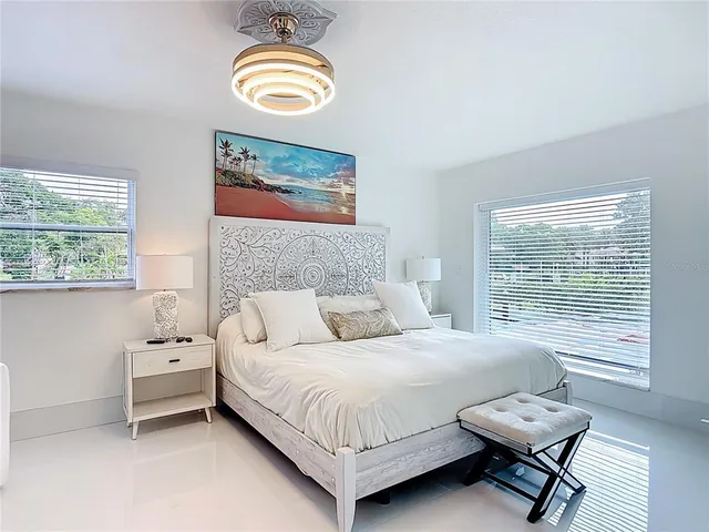 a bathroom with a granite countertop sink a toilet a mirror and shower