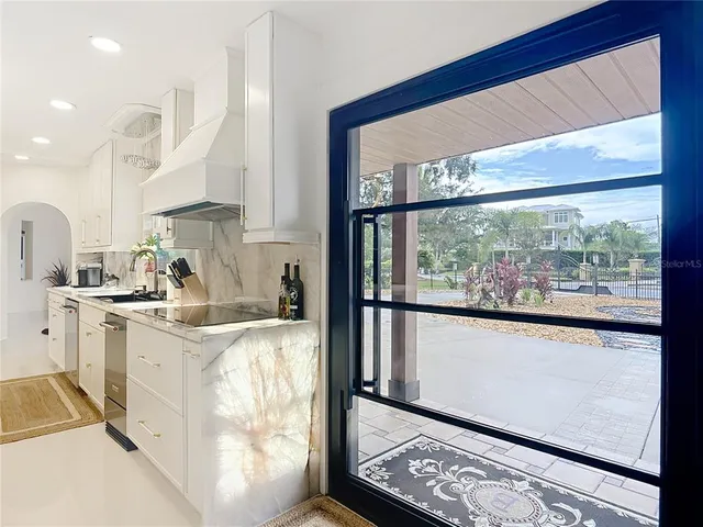 a kitchen with a sink a stove and cabinets