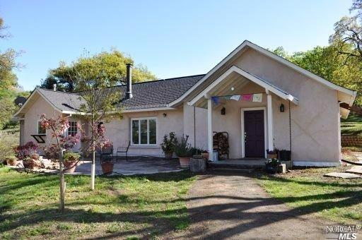 a front view of house with a garden