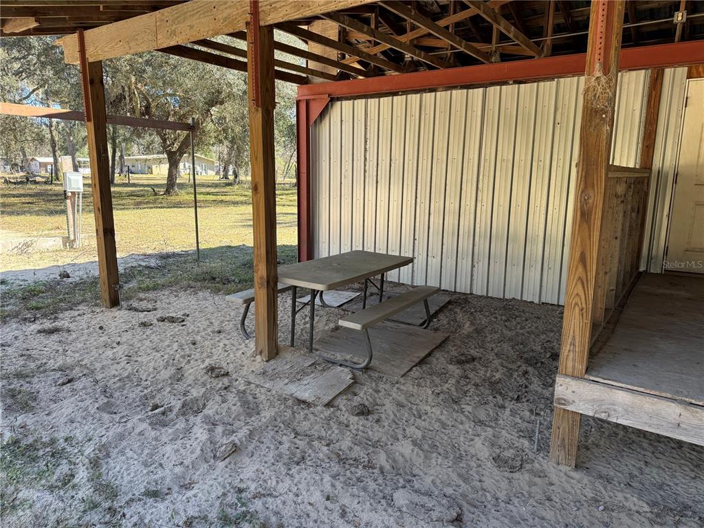 18630 Bradshaw Road Dade City, FL 33523 - Photo 10 of 43 a view of a backyard with table and chairs