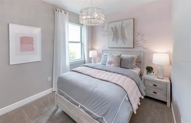 a bedroom with a bed and a chandelier