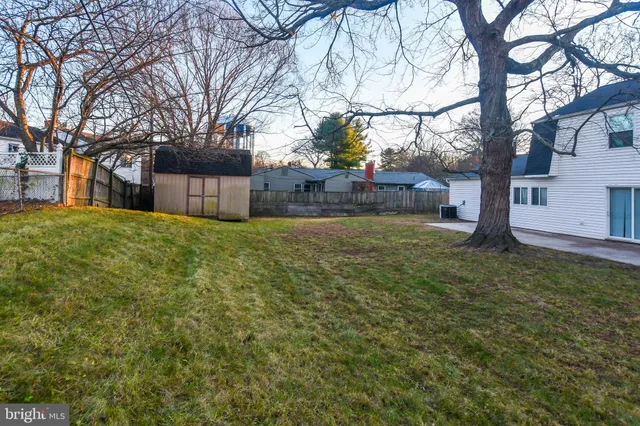 a view of a house with white door and a tree