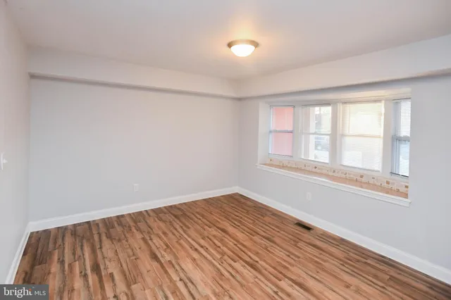 a view of a kitchen with wooden floor and a sink