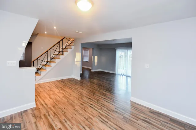 a large kitchen with stainless steel appliances granite countertop a lot of counter space and wooden floors