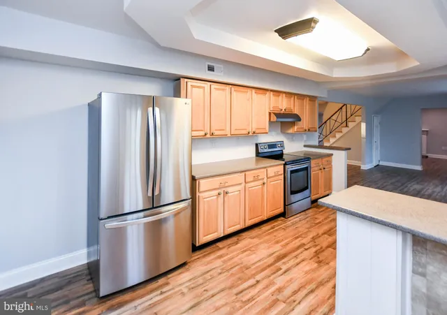 a kitchen with stainless steel appliances granite countertop a stove sink and cabinets