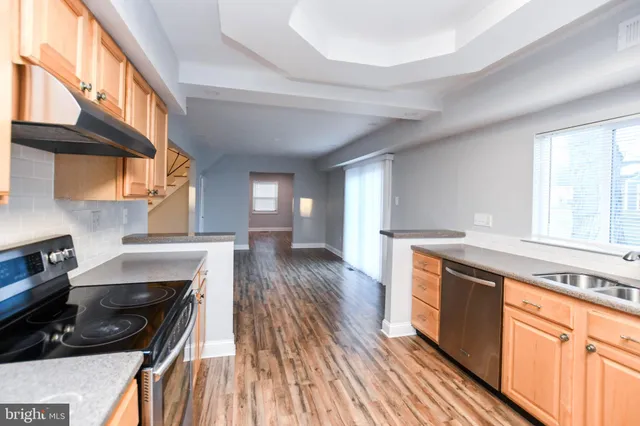 a view of a room with wooden floor and windows