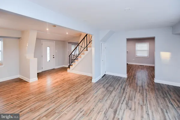 a view of an empty room with a fireplace and a window