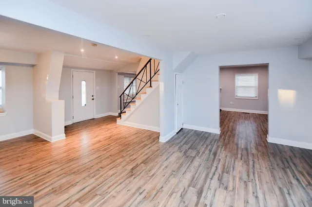 a view of an empty room with a fireplace and a window