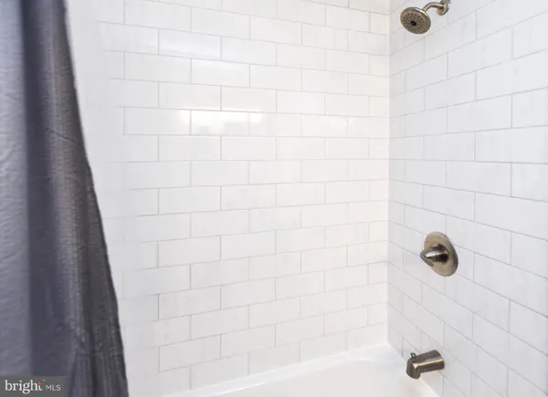 a bathroom with a bathtub and shower