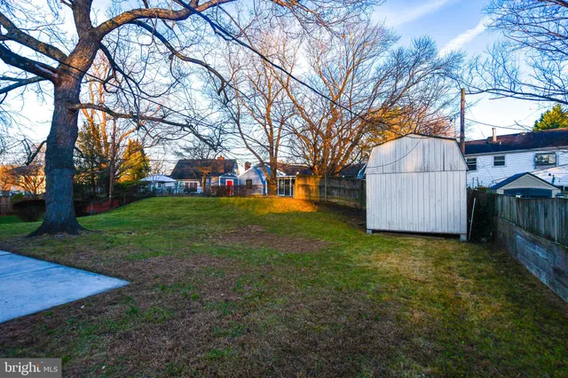 a view of a yard with a house and large trees