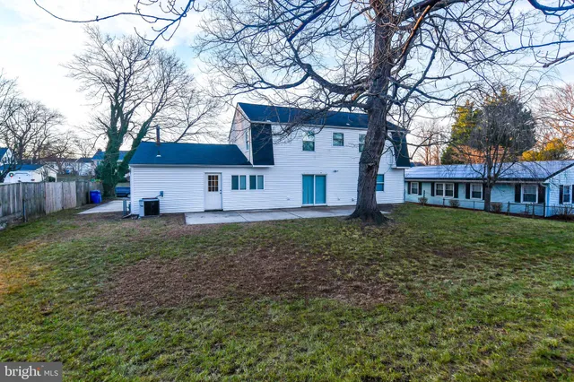 a view of a white house with a yard