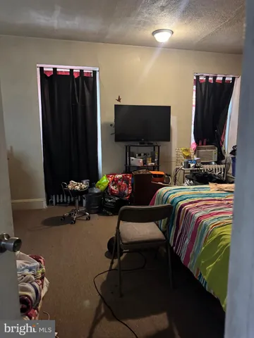 a bed sitting in a bedroom next to a window