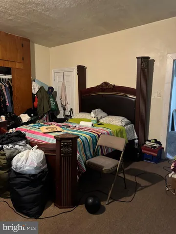 a bedroom with a bed and a closet