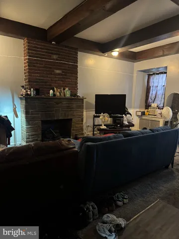 a living room with furniture gym equipment and a fireplace