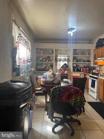 a kitchen with granite countertop a refrigerator and a stove top oven