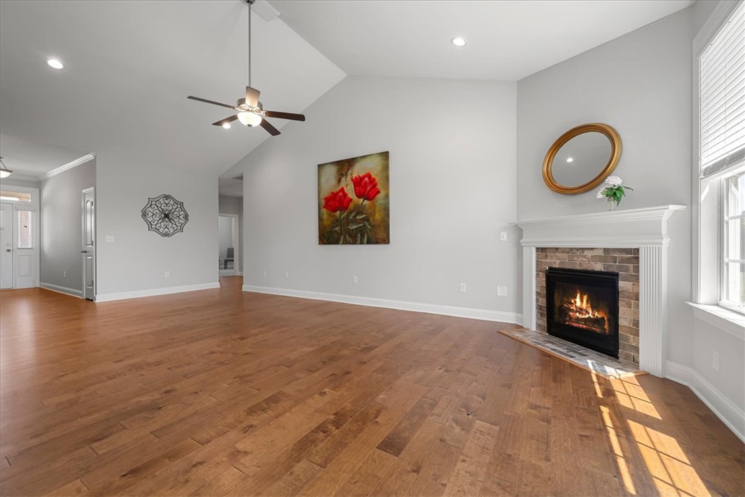 21 Barron Glenn Way Anderson, SC 29621 - Photo 12 of 48 This living room offers durable wood flooring and a corner fireplace.