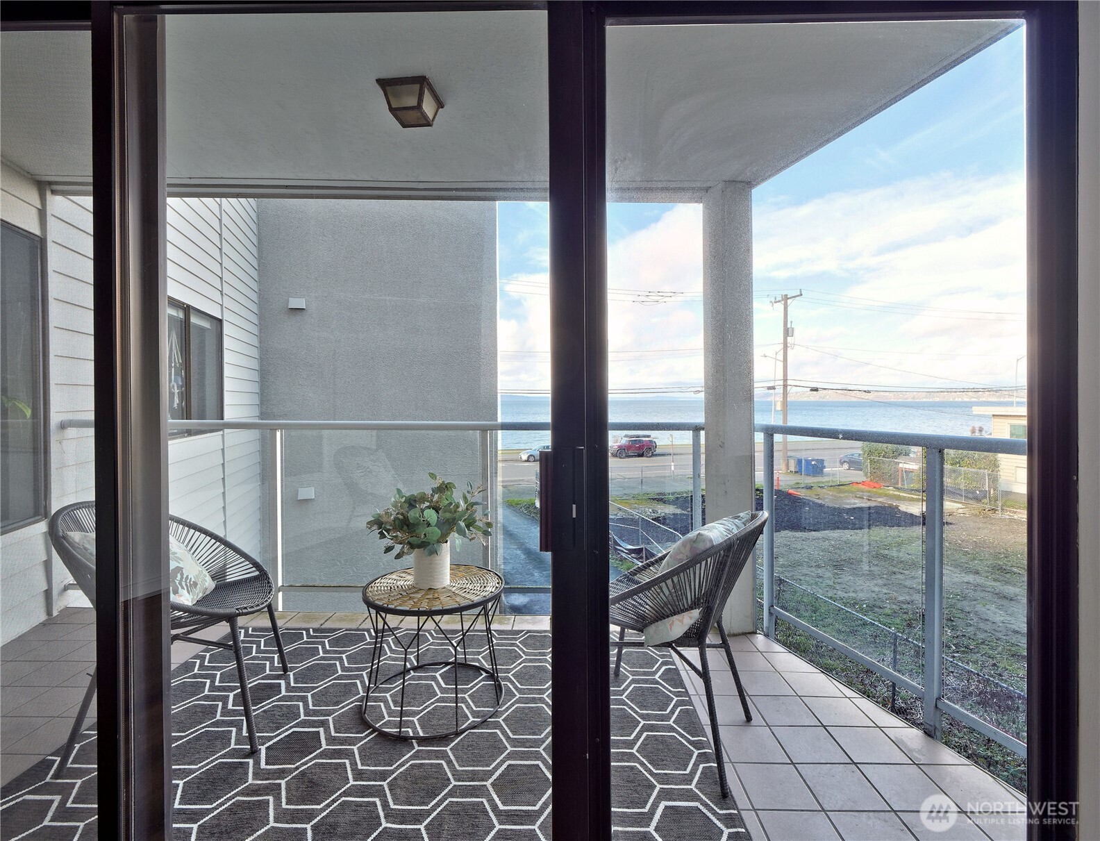 2104 Alki Avenue Southwest, Unit 205 Seattle, WA 98116 - Photo 11 of 39 a view of a room with furniture and floor to ceiling window
