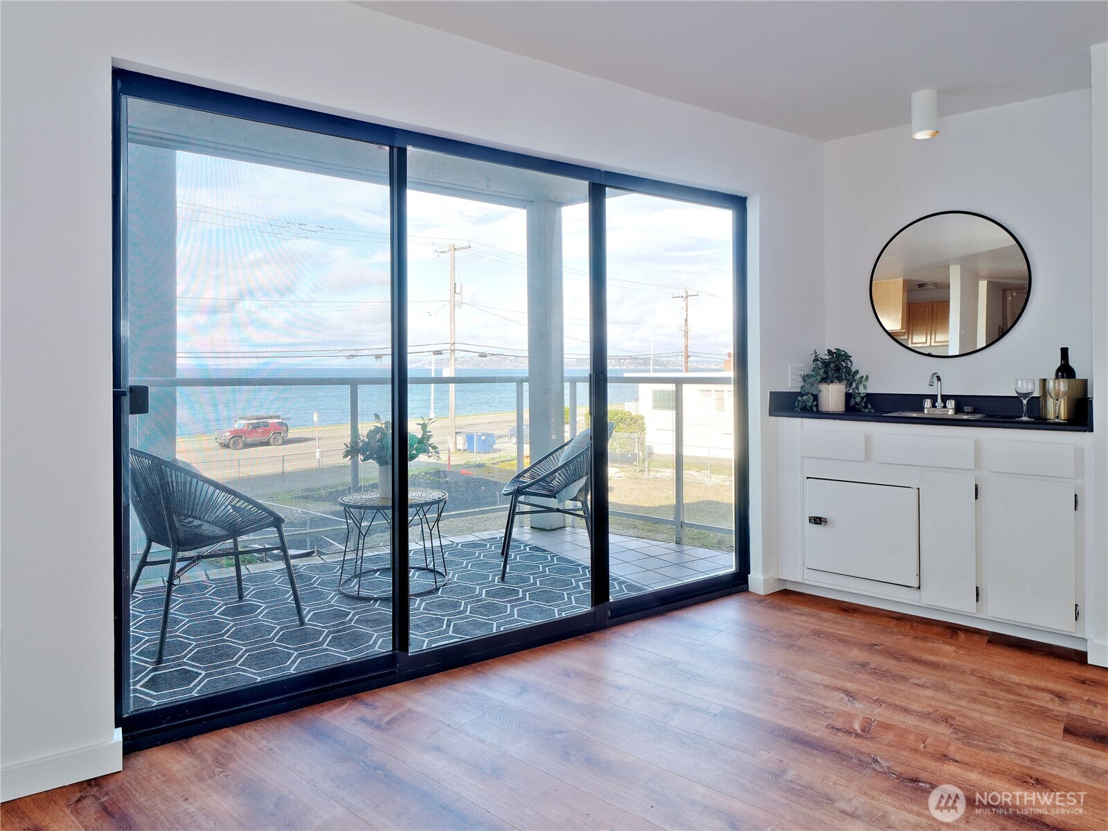 2104 Alki Avenue Southwest, Unit 205 Seattle, WA 98116 - Photo 15 of 39 a view of a room with wooden floor and windows