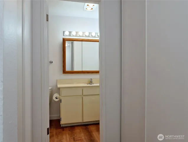 a bathroom with a sink a mirror and a window