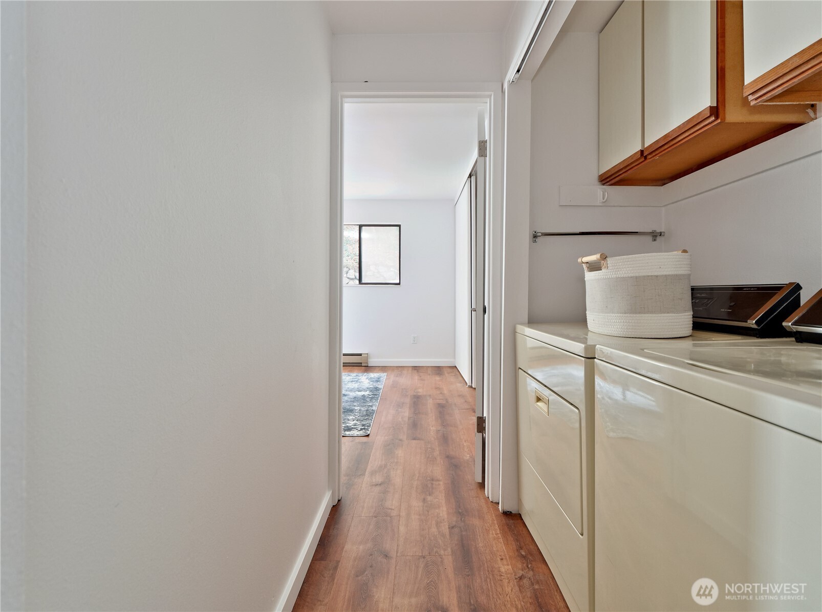 2104 Alki Avenue Southwest, Unit 205 Seattle, WA 98116 - Photo 22 of 39 a view of a hallway with wooden floor