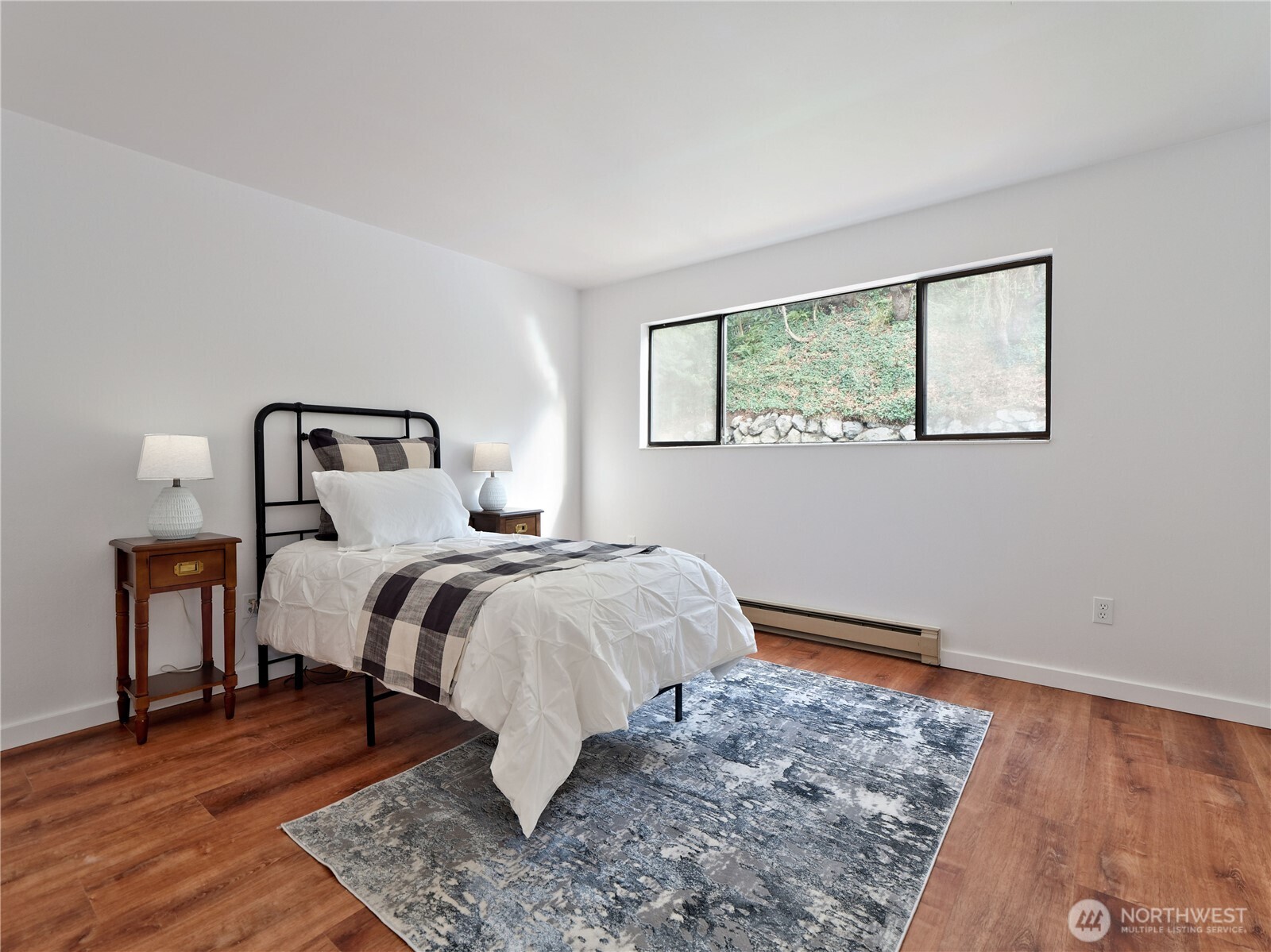 2104 Alki Avenue Southwest, Unit 205 Seattle, WA 98116 - Photo 25 of 39 a bedroom with a bed and wooden floor