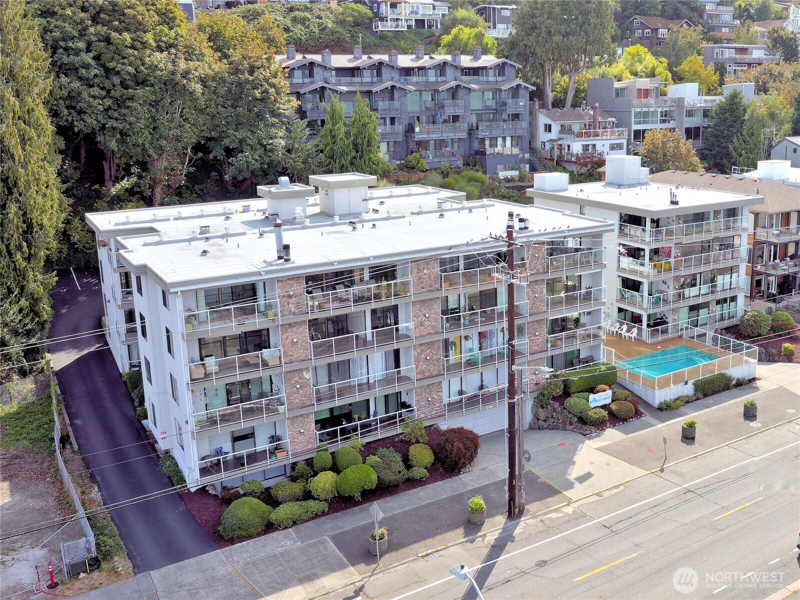 2104 Alki Avenue Southwest, Unit 205 Seattle, WA 98116 - Photo 34 of 39 a large building with a street