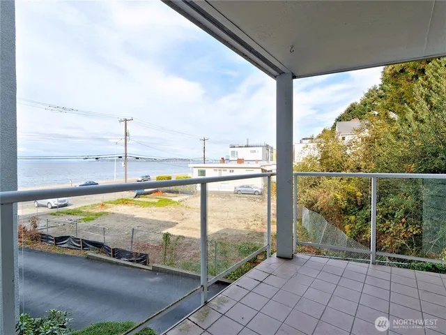 a view of a balcony with floor to ceiling windows and city view