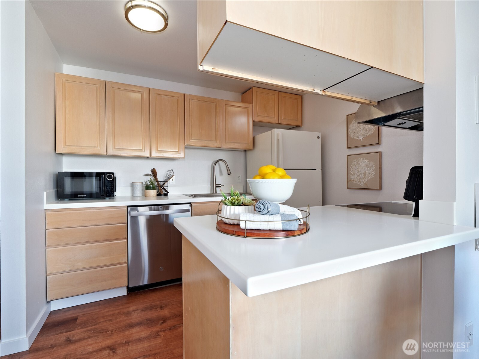 2104 Alki Avenue Southwest, Unit 205 Seattle, WA 98116 - Photo 4 of 39 a kitchen with a sink appliances and cabinets