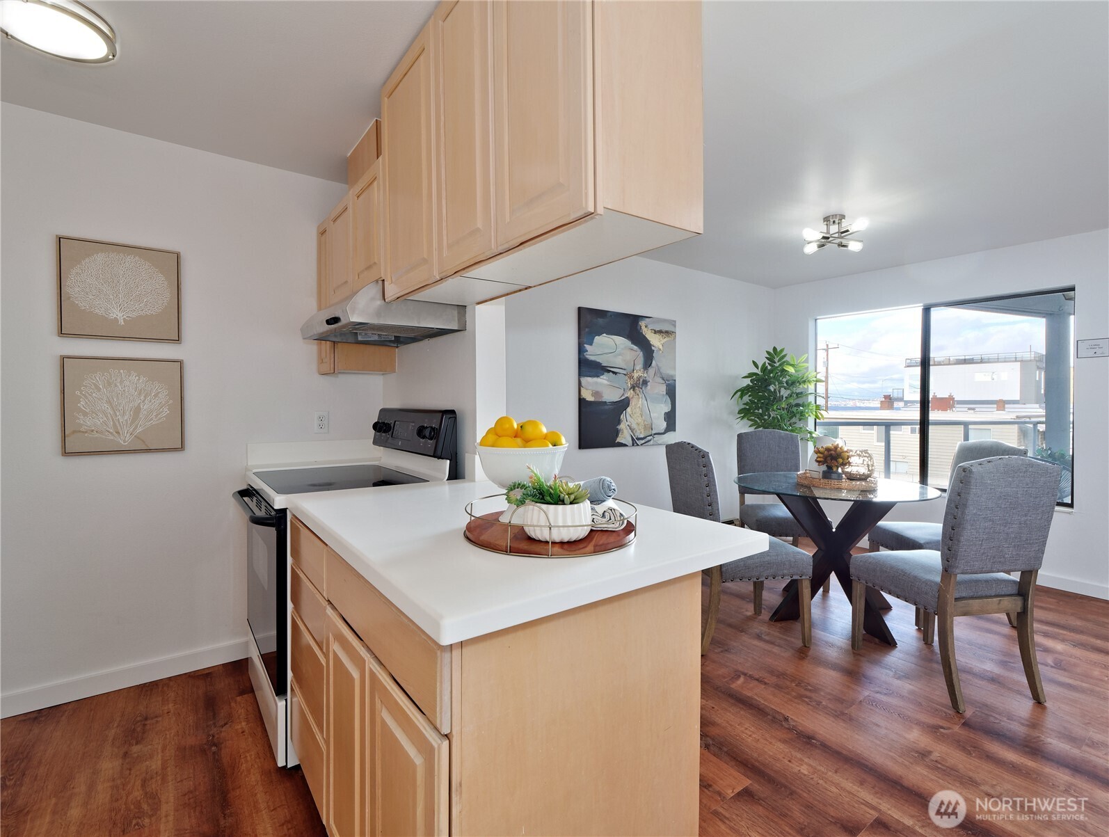 2104 Alki Avenue Southwest, Unit 205 Seattle, WA 98116 - Photo 6 of 39 a view of a dining room with furniture and wooden floor