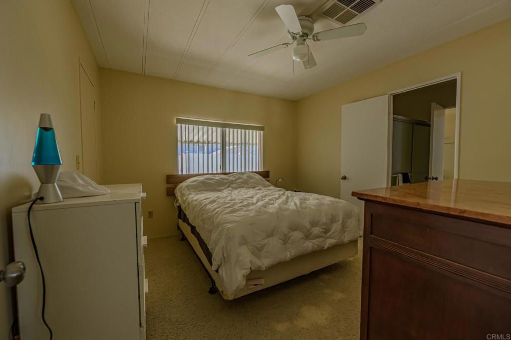4650 Dulin Road, Unit 27 Fallbrook, CA 92003 - Photo 26 of 37 a bedroom with a bed and a dresser