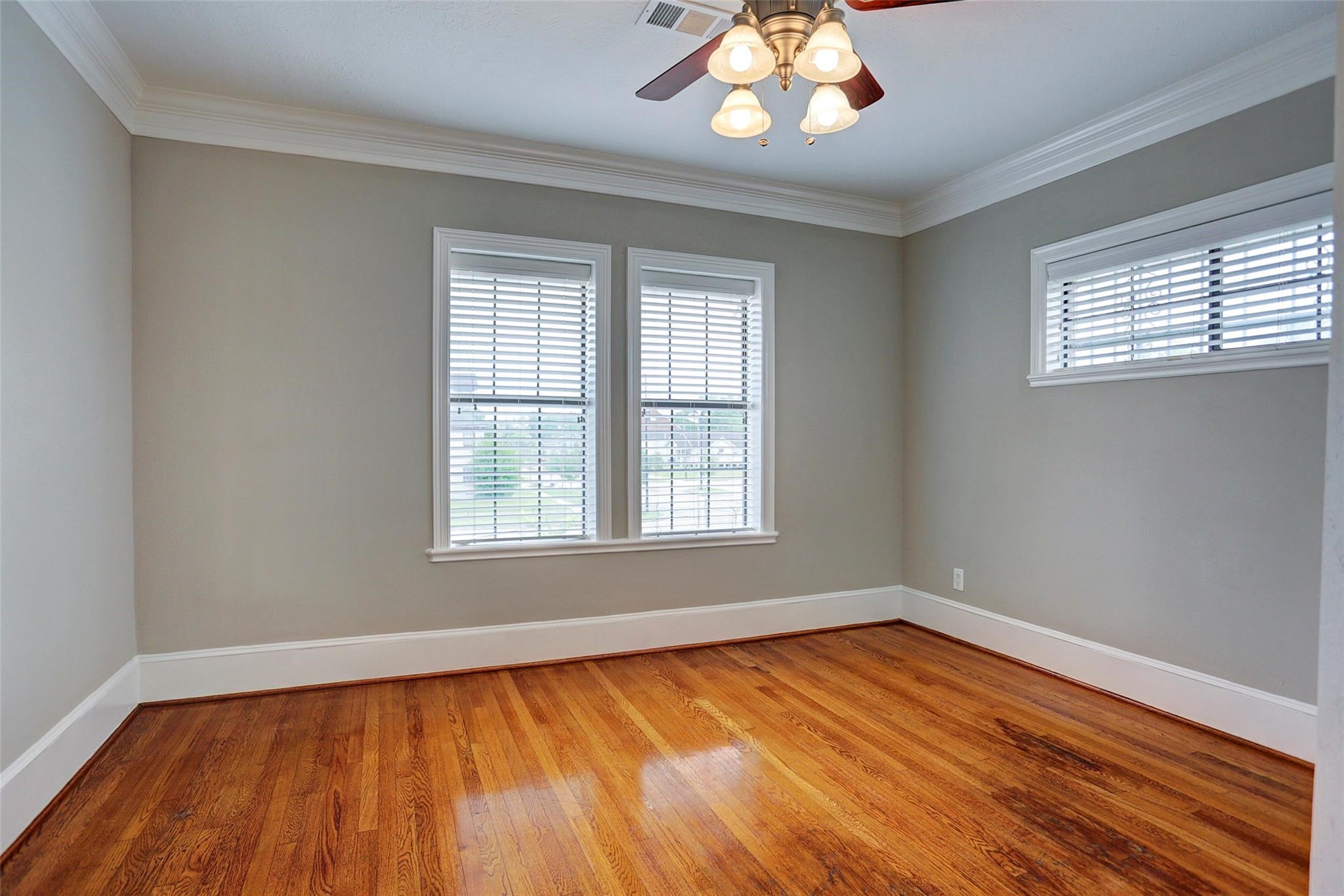 2709 Blodgett Street Houston, TX 77004 - Photo 12 of 27 a view of an empty room with wooden floor and a window