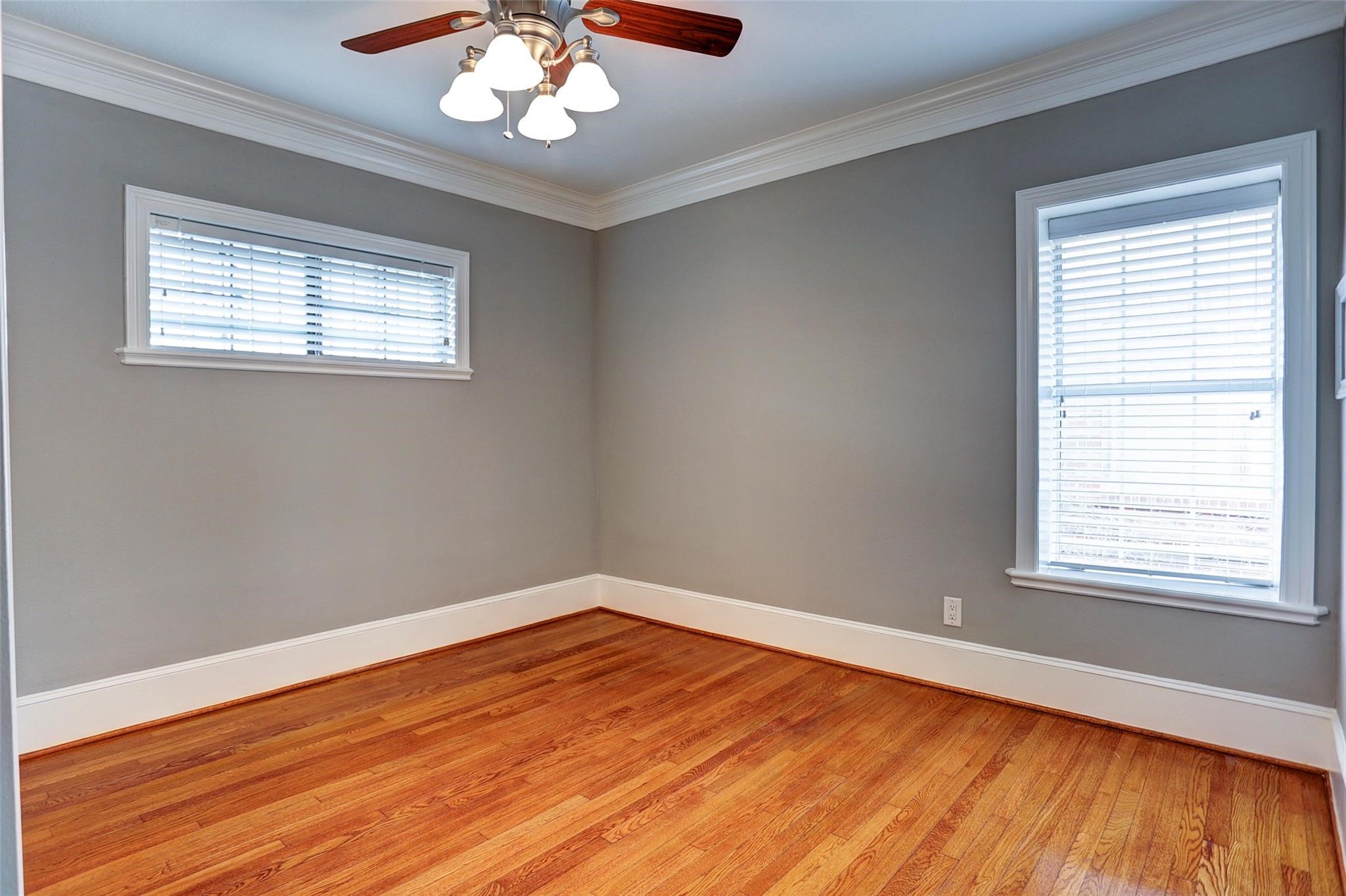 2709 Blodgett Street Houston, TX 77004 - Photo 13 of 27 a view of an empty room with wooden floor and a window