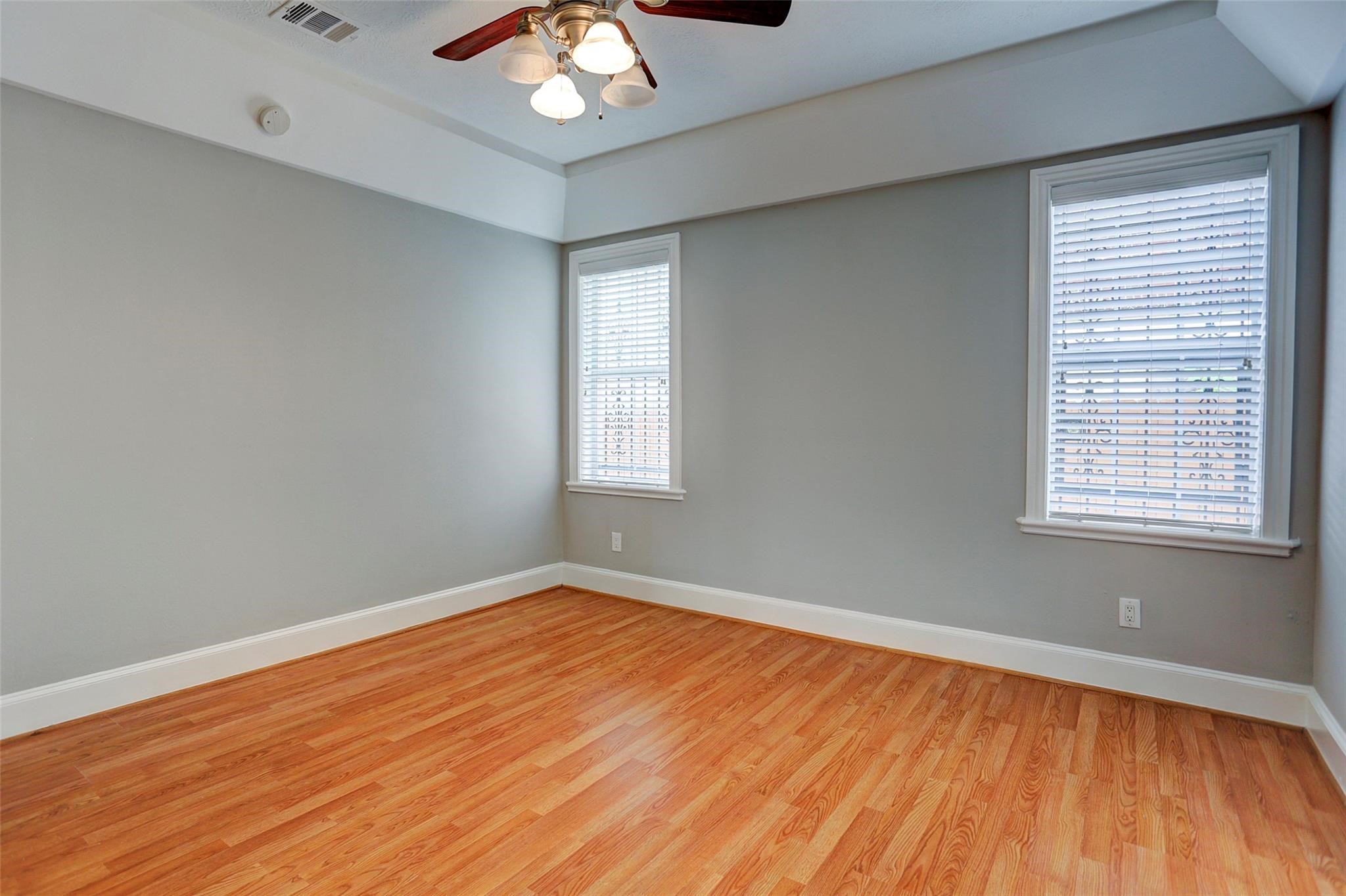 2709 Blodgett Street Houston, TX 77004 - Photo 15 of 27 an empty room with wooden floor and windows