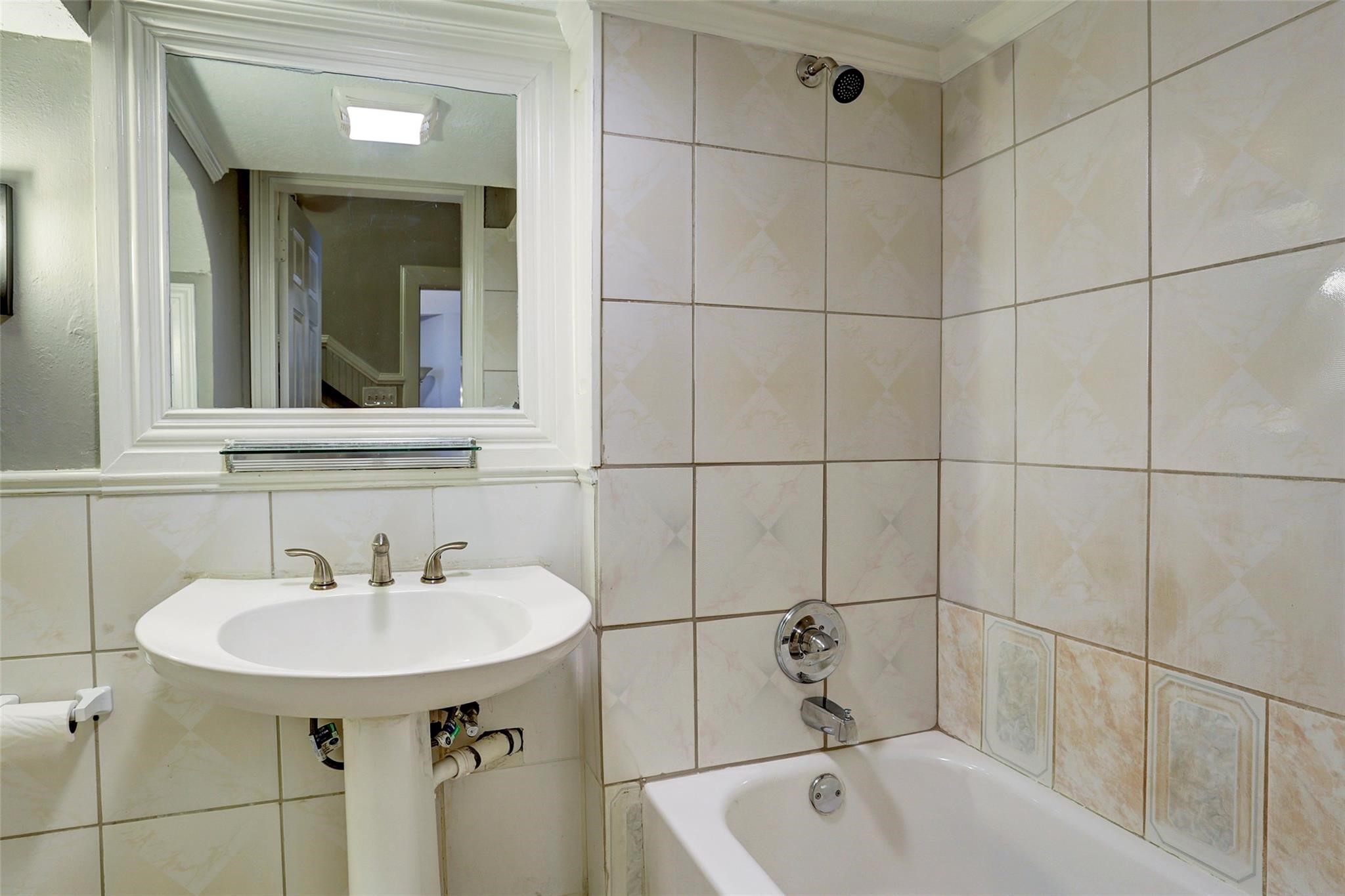 2709 Blodgett Street Houston, TX 77004 - Photo 18 of 27 a bathroom with a sink and mirror