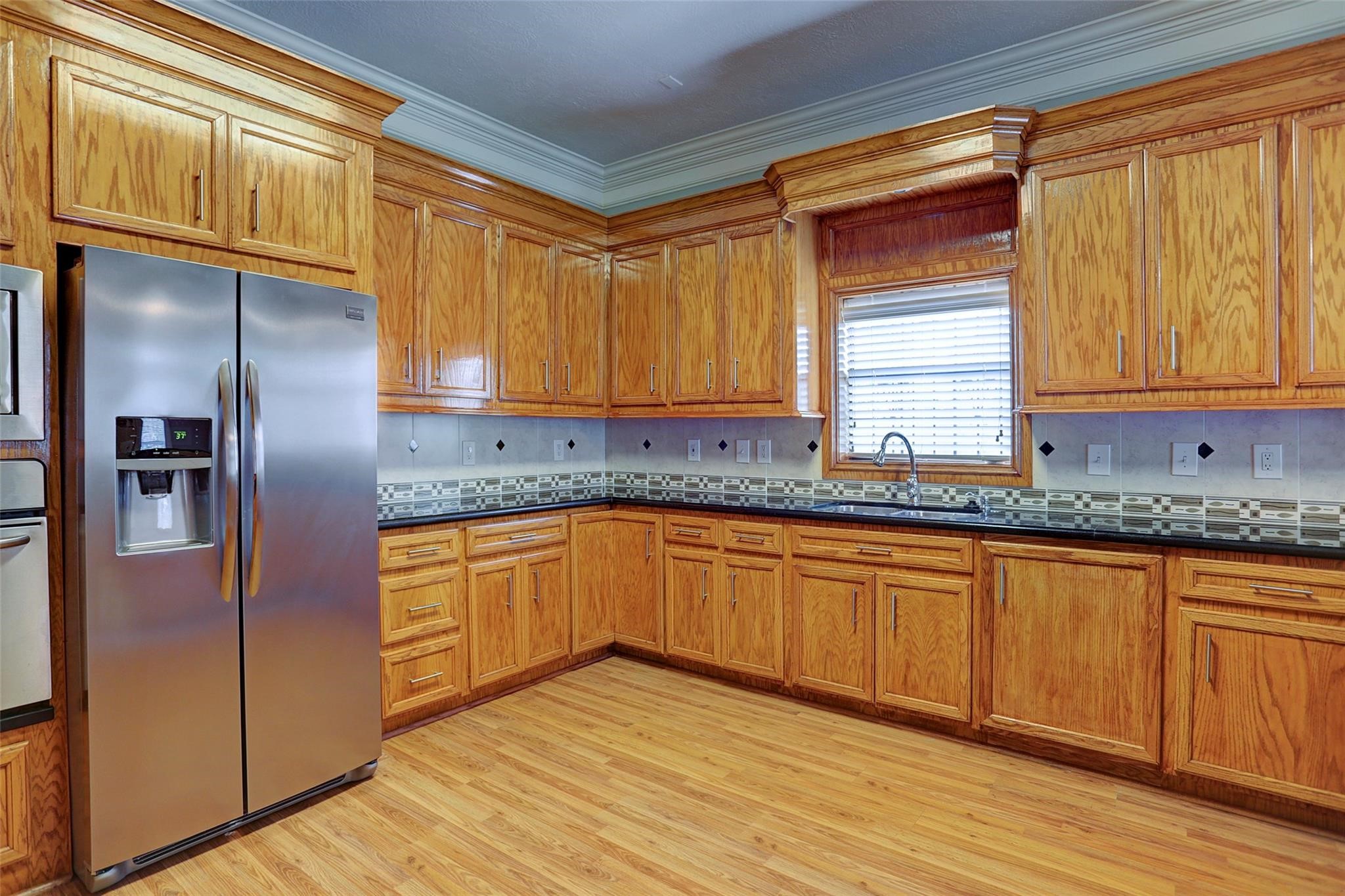 2709 Blodgett Street Houston, TX 77004 - Photo 6 of 27 a kitchen with stainless steel appliances granite countertop a refrigerator and a sink