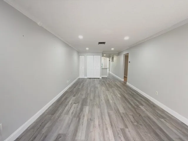 a view of wooden floor and windows in a room