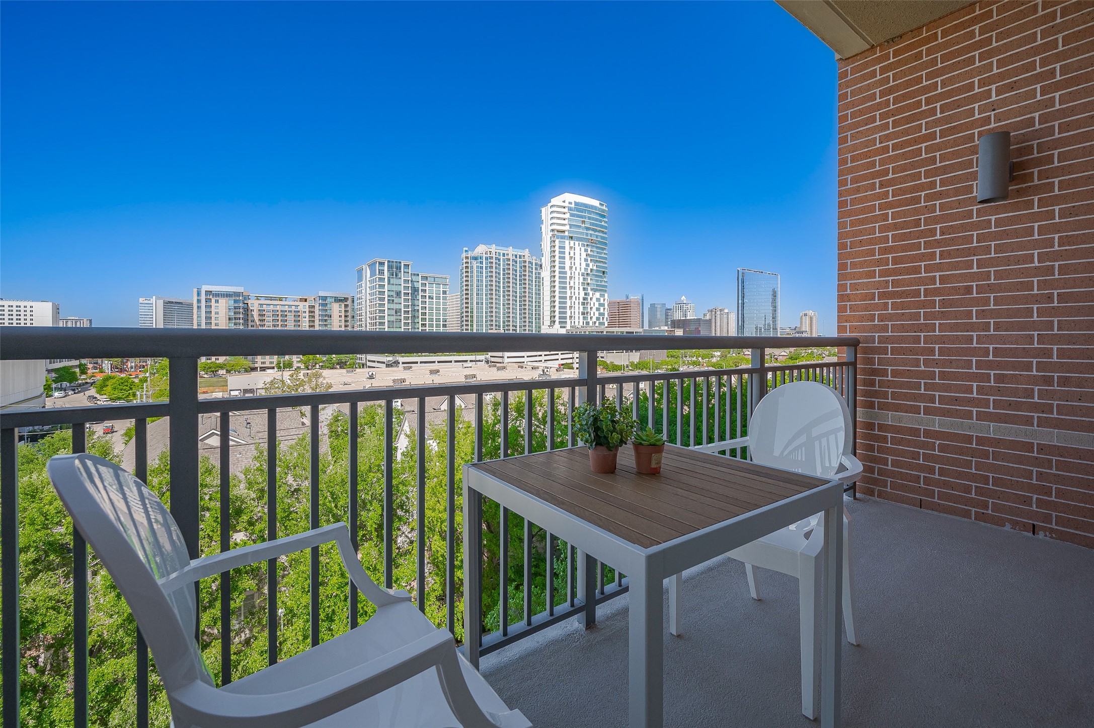 2207 Bancroft Lane, Unit 604 Houston, TX 77027 - Photo 1 of 40 a view of a balcony with two chairs and a deck