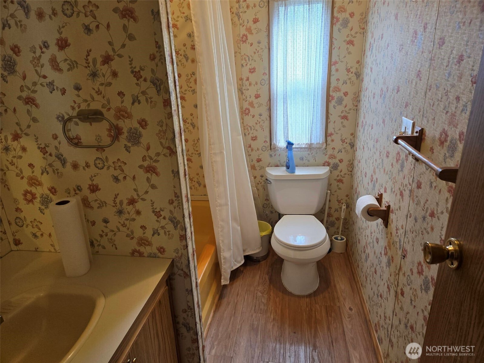 212 Old Owen Road, Unit 59 Sultan, WA 98294 - Photo 11 of 18 a bathroom with a toilet and a shower curtain