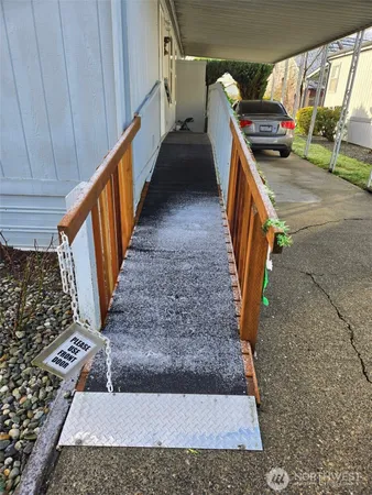 a view of a door and chair in front of a house