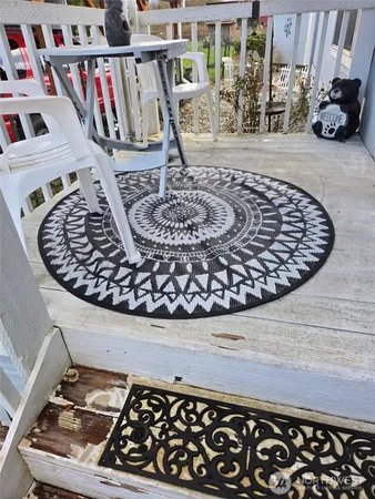 a balcony with table and chairs