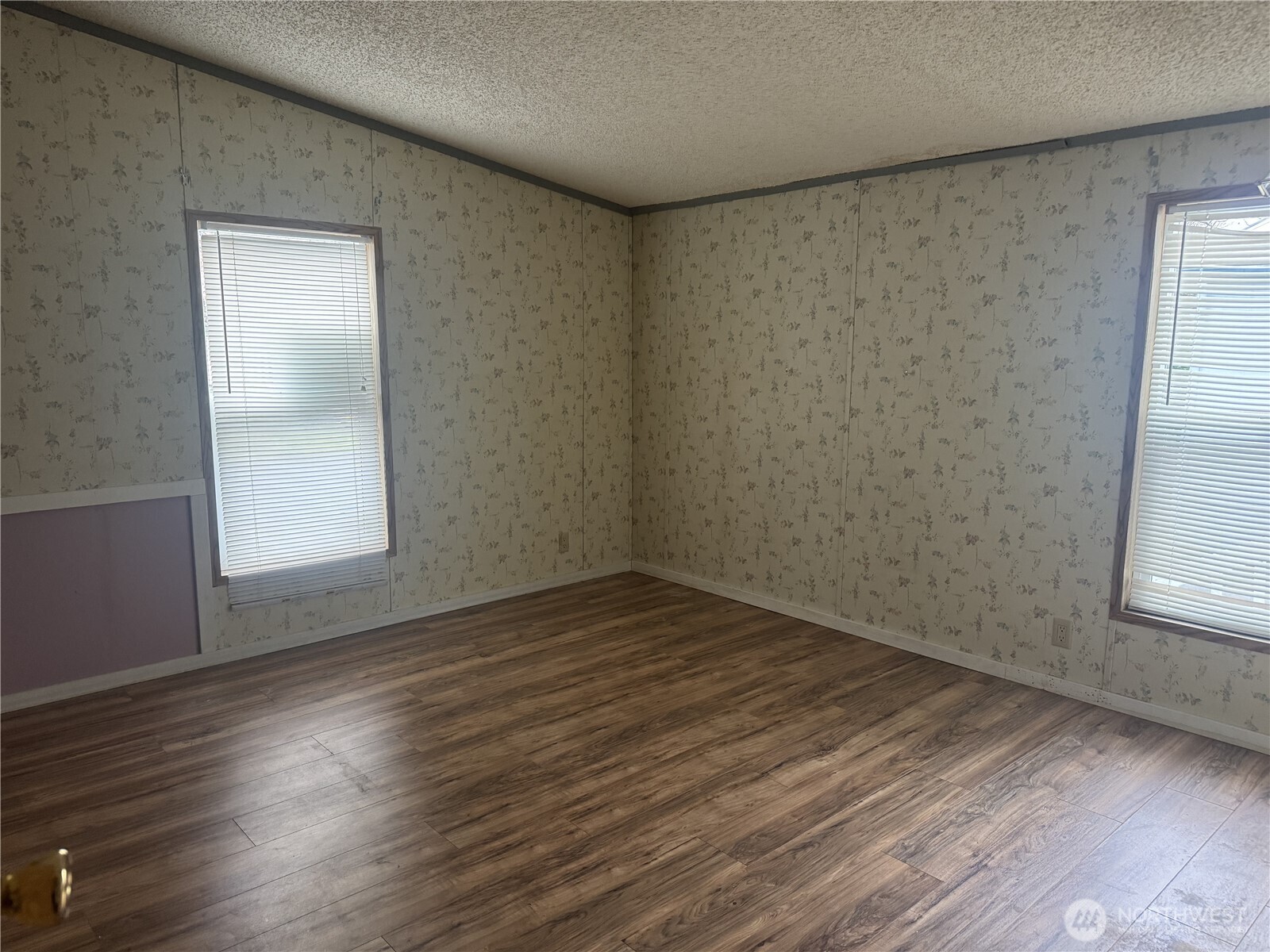 212 Old Owen Road, Unit 59 Sultan, WA 98294 - Photo 6 of 13 an empty room with wooden floor and windows