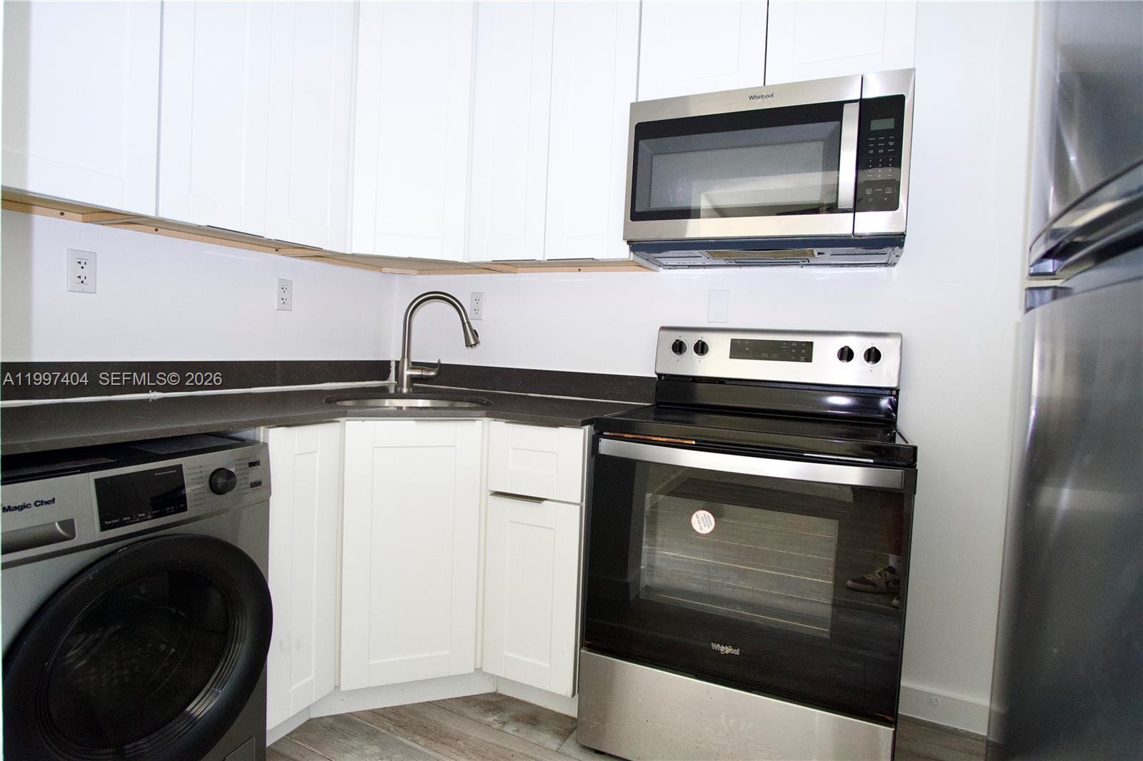 1036 Southwest 5th Street, Unit 12 Miami, FL 33130 - Photo 13 of 19 a kitchen with a stove and a microwave