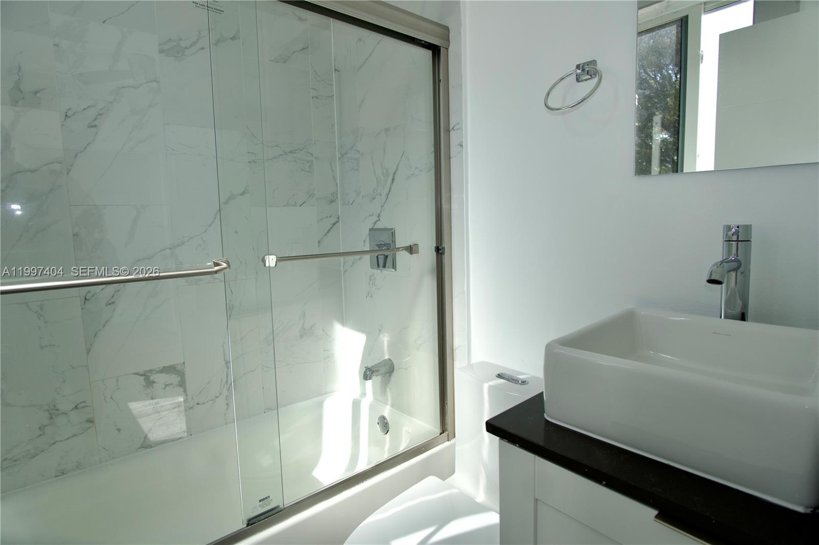 1036 Southwest 5th Street, Unit 12 Miami, FL 33130 - Photo 14 of 19 a bathroom with a sink and a shower